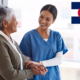 Medical Assistant helping elder woman - Colorado Program